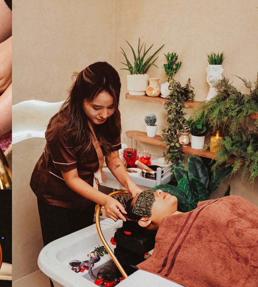 A therapist performing a Korean head spa treatment over a rose-petal basin.